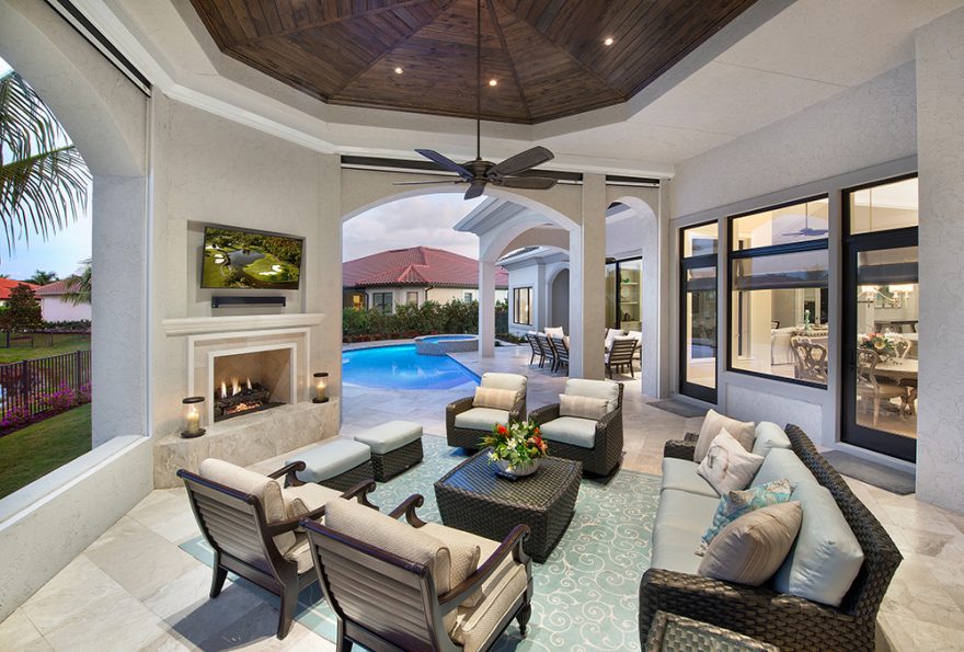 This COVERED LANAI with an octagon shaped tongue-and-groove ceiling provides a relaxing outdoor living area where dad can watch the game and enjoy a beer in front of a fireplace, just steps away from the pool.