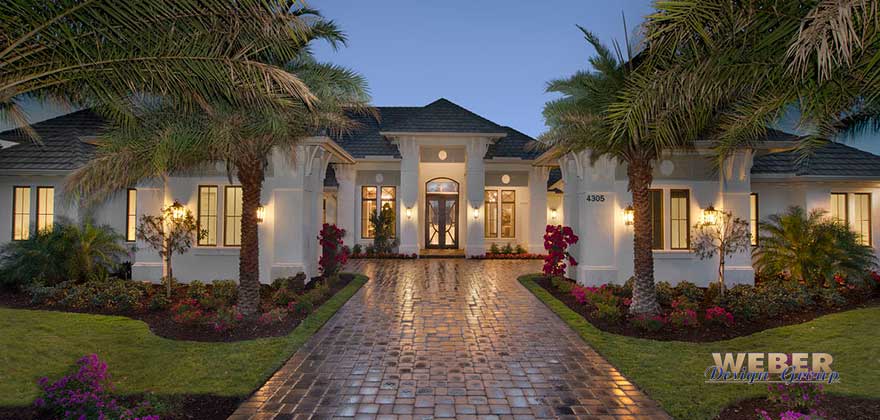 Calusa House Plan exterior showcasing transitional coastal and West Indies architecture with stucco detailing, tall windows, and covered lanai.